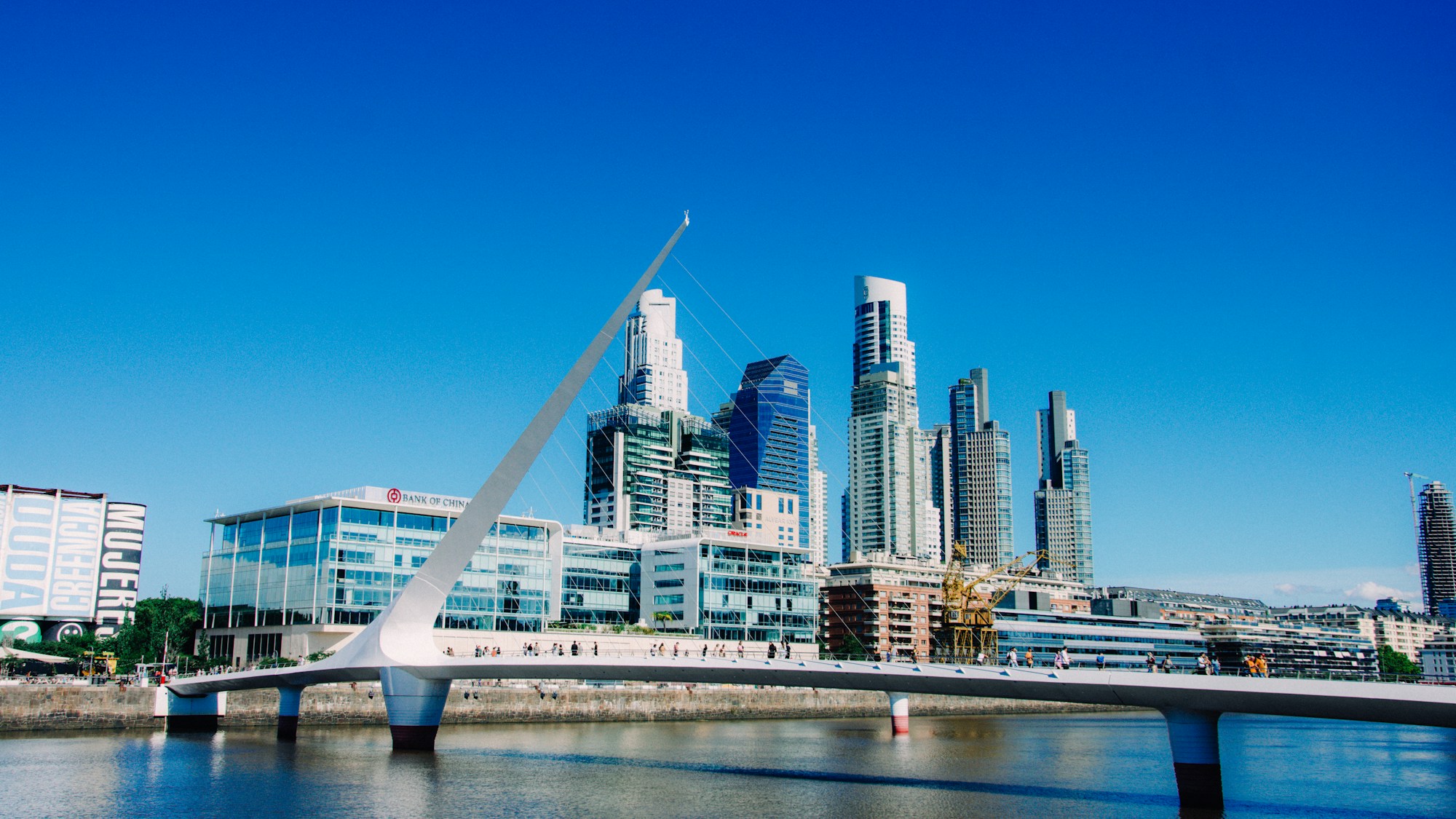 Bridge over the river with Buenos Aires residential towers in the background.
