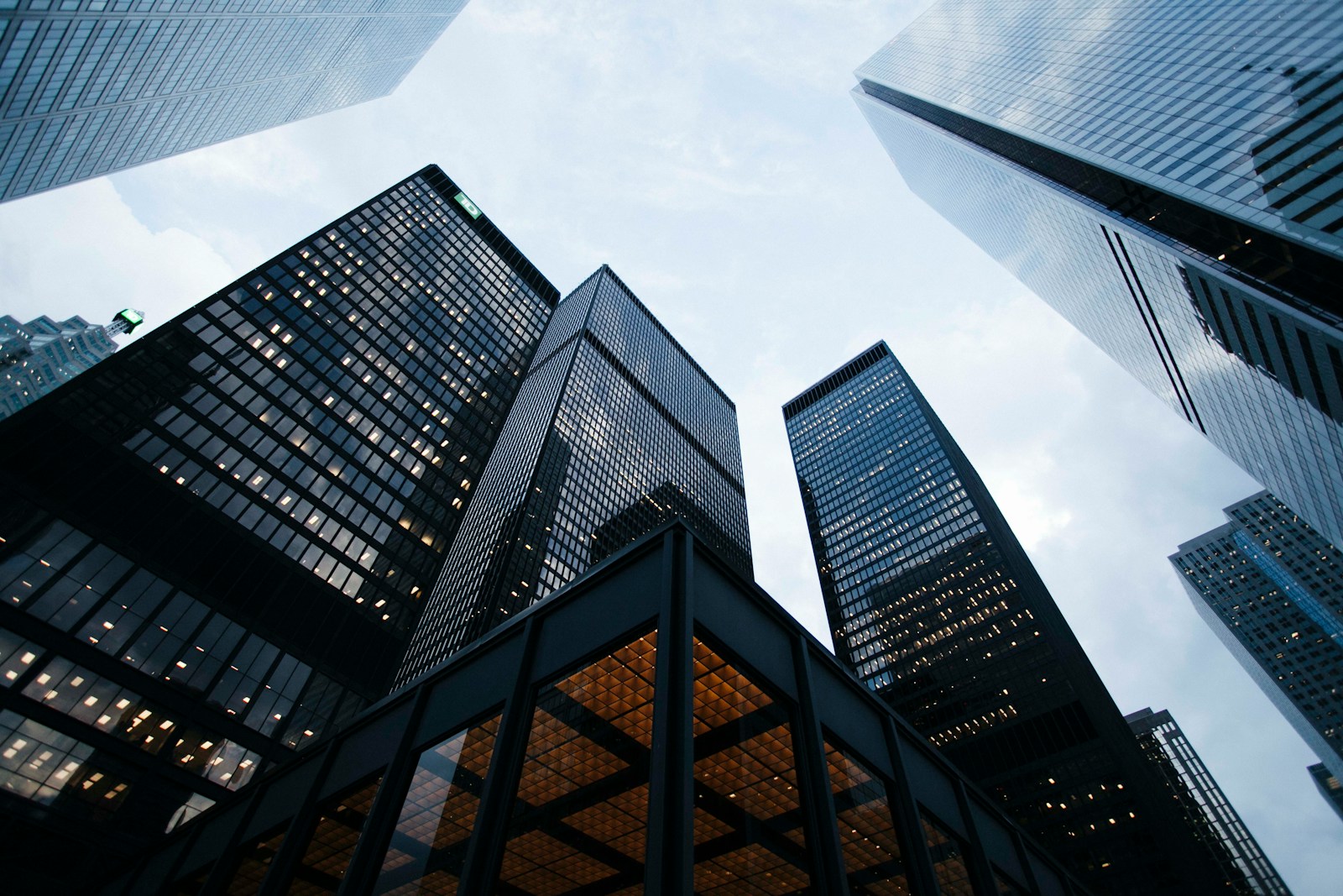 Modern high-rise residential towers seen from below against the sky.